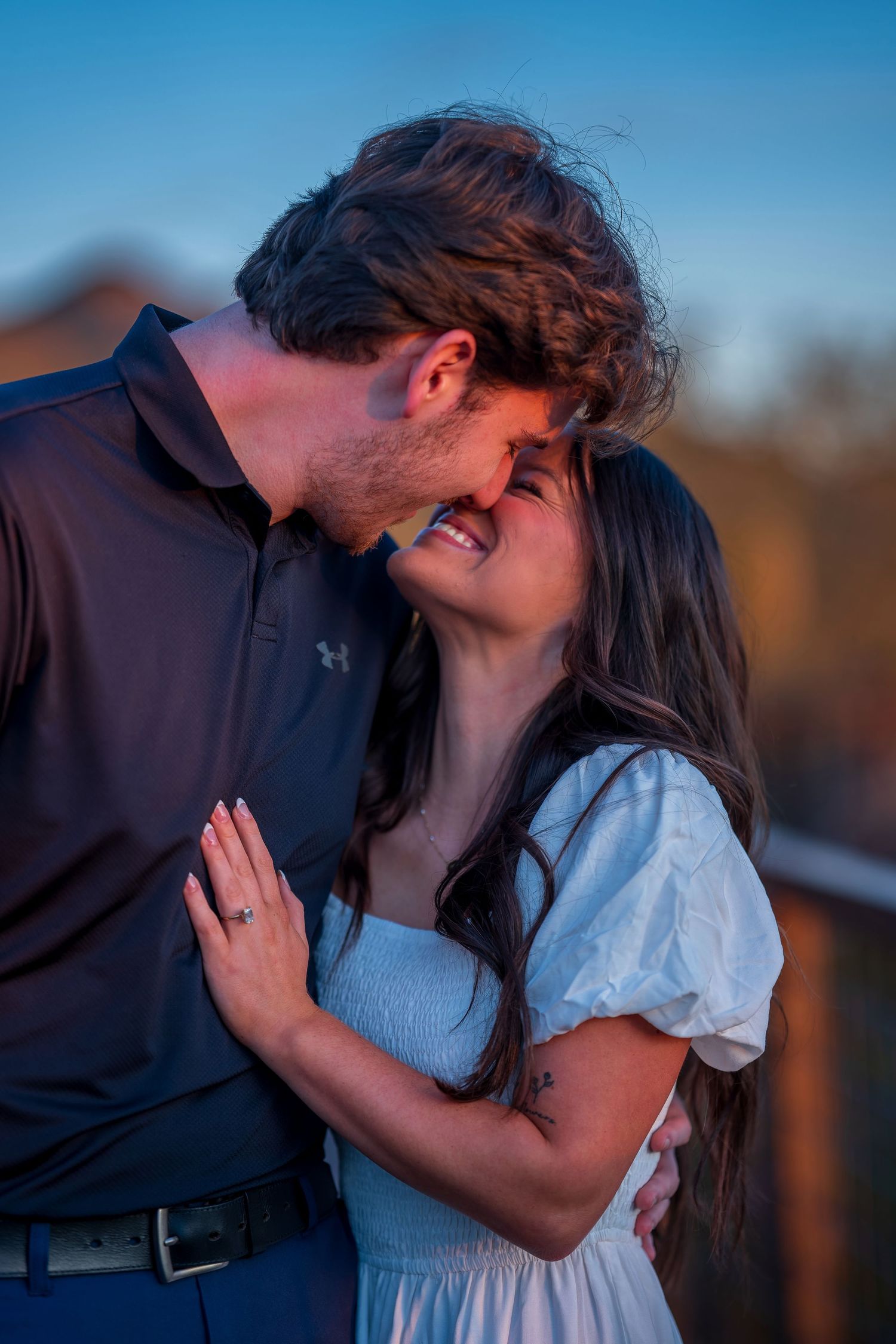 Close-up shot of a couple sharing a tender moment during their desert photoshoot.