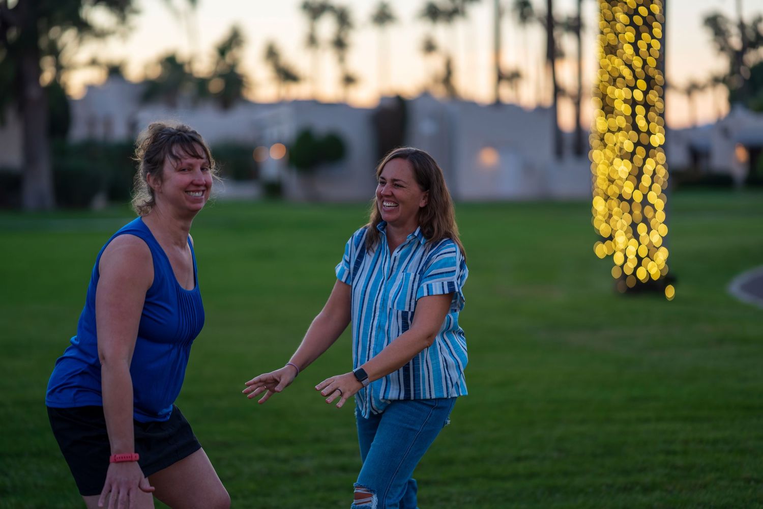 Action shots of family members playing and jumping during sunset photo session.