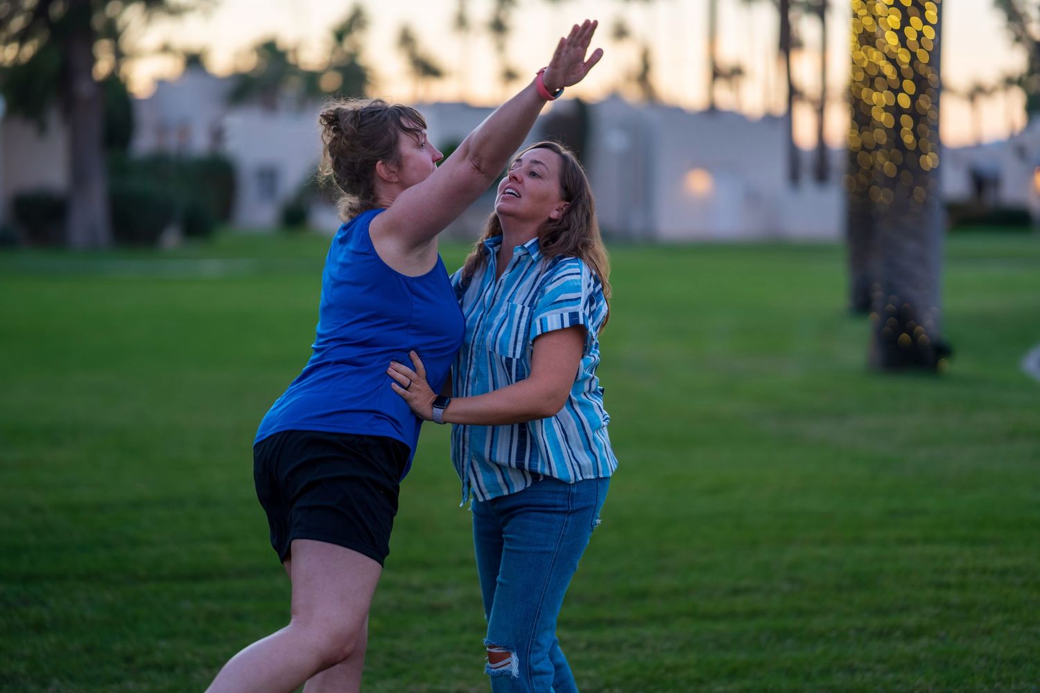Playful family moments captured during outdoor photo session at dusk.