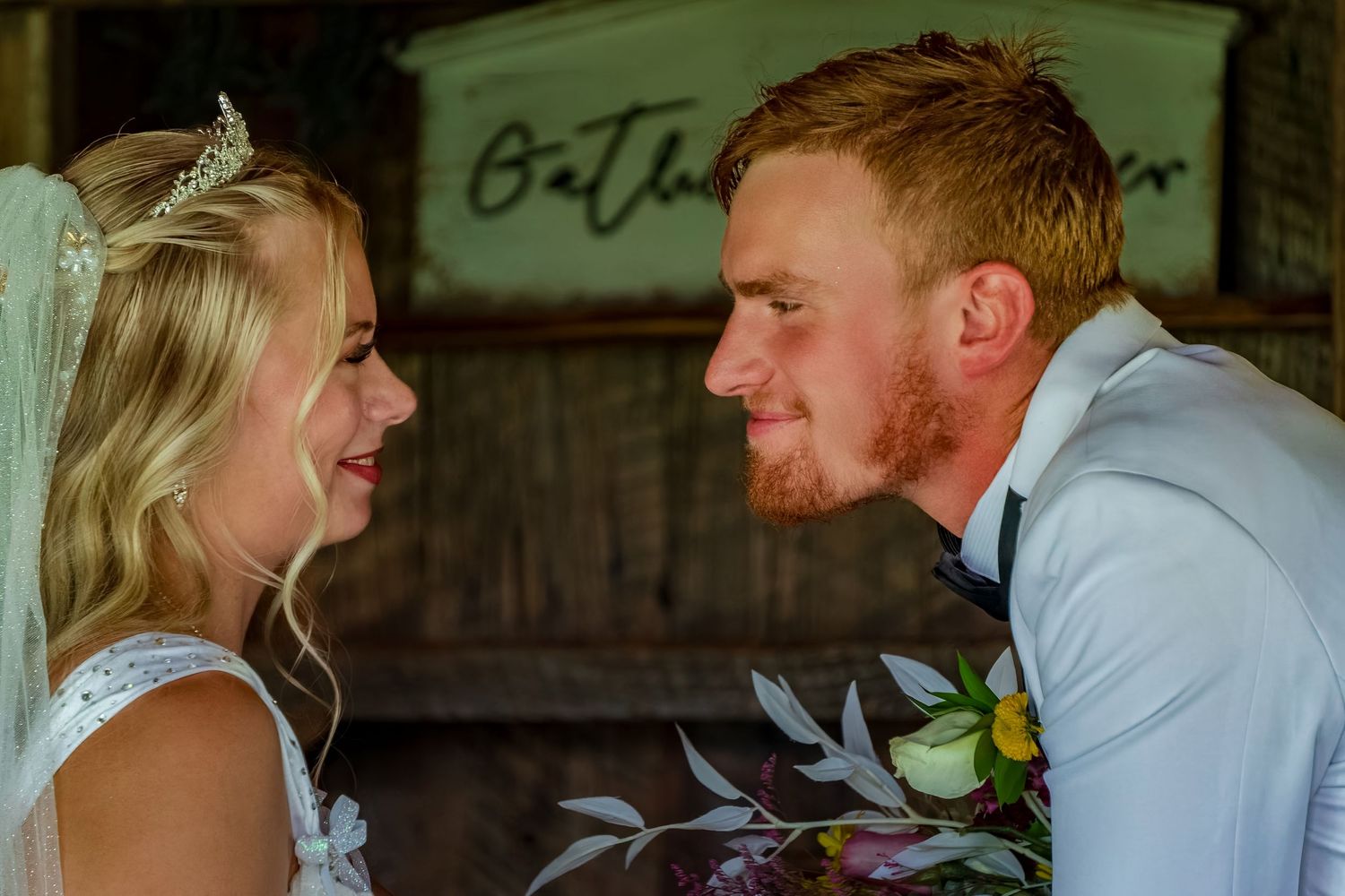 Romantic dance moment in rustic barn with vintage decor.