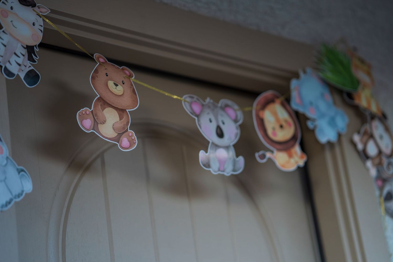 Decorative animal-themed party banner with safari creatures hanging on display.