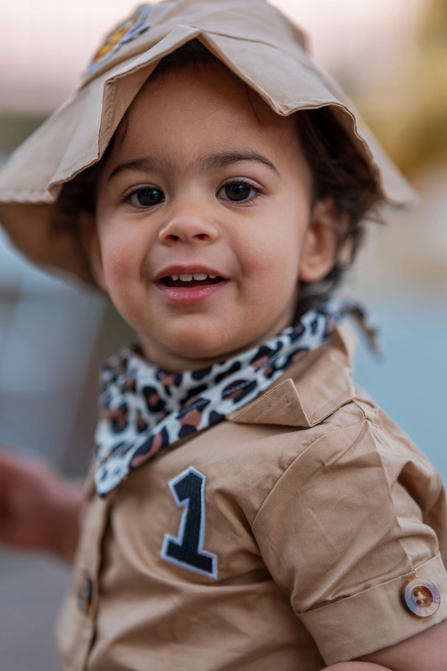 Close-up of safari explorer outfit with tan hat and animal print bandana.