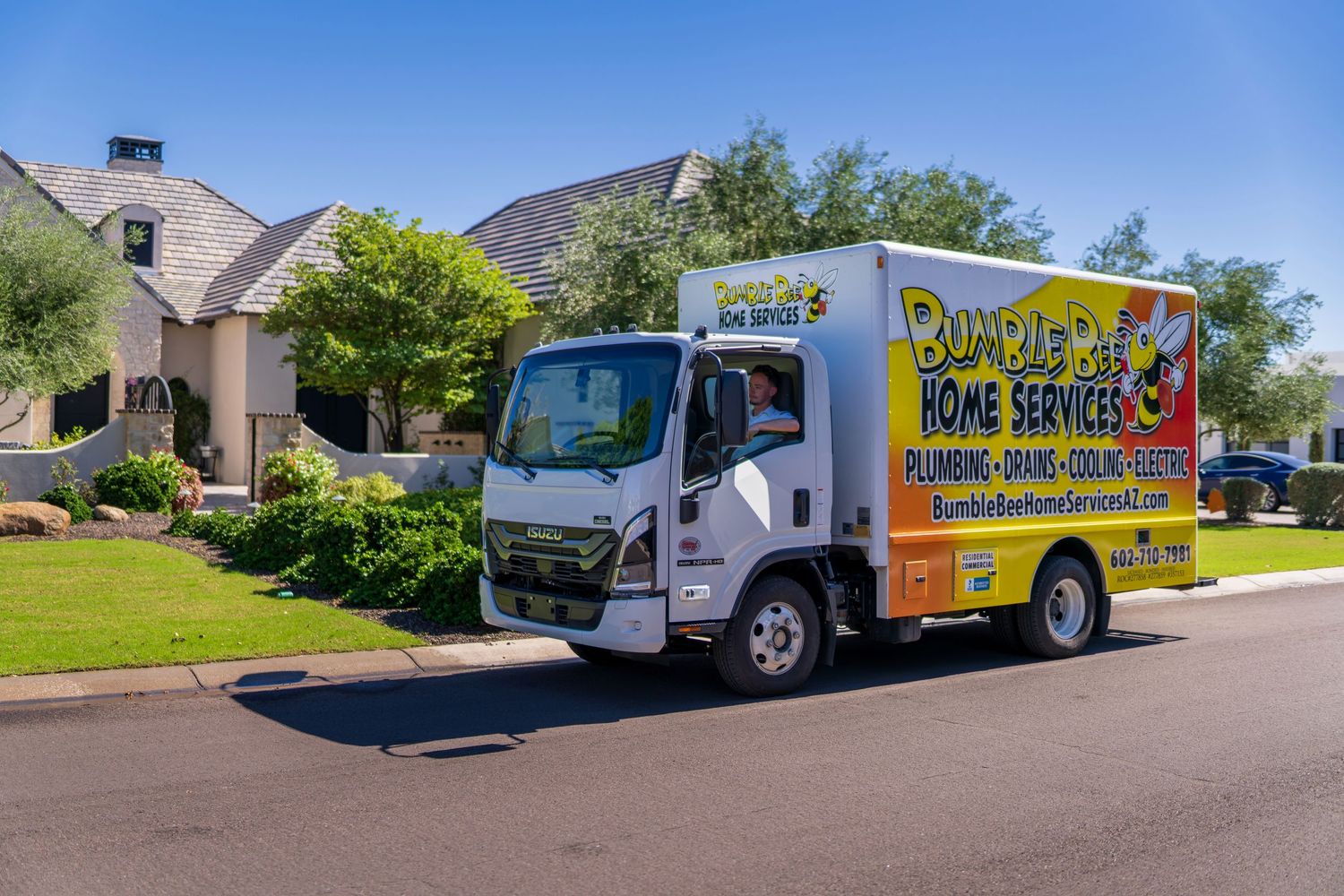 A fleet of colorful service vans parked in a residential neighborhood.