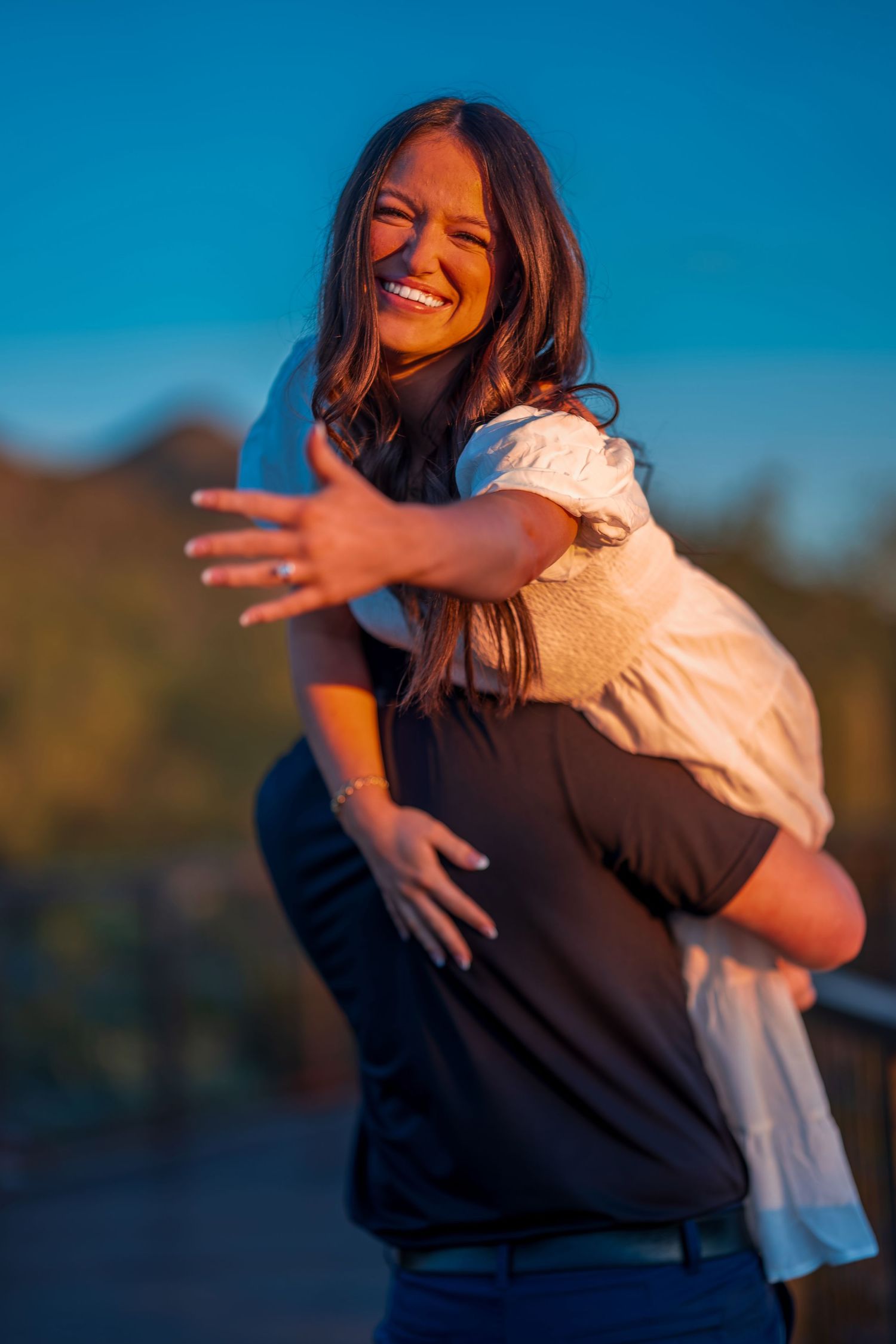 Happy couple sharing an intimate moment during a sunset photoshoot in the desert.