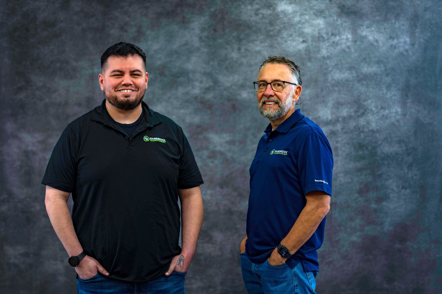 Staff members wearing company branded polos stand together for professional headshots.