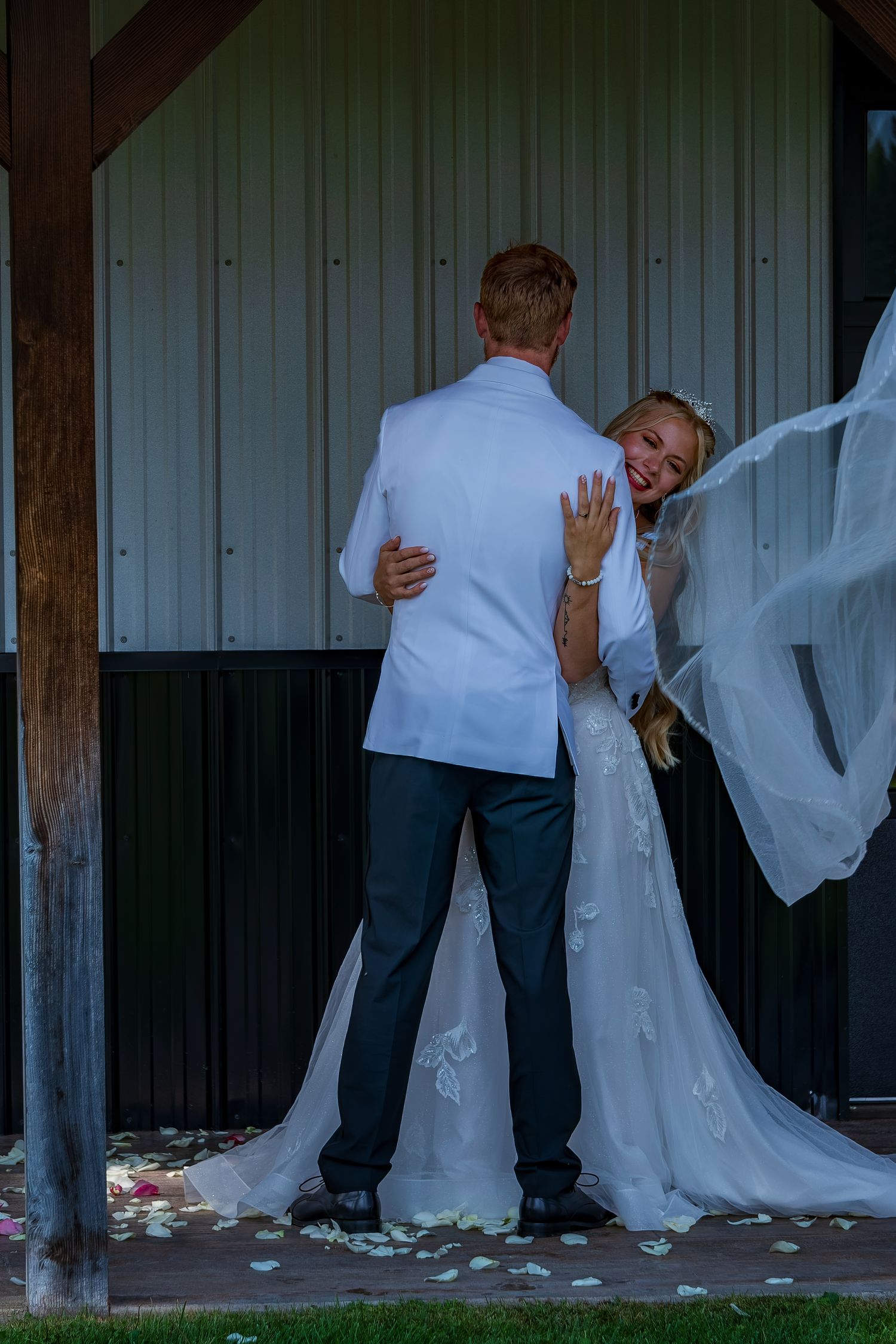 Sequence of romantic wedding poses showing the couple's playful interaction against rustic backdrop.