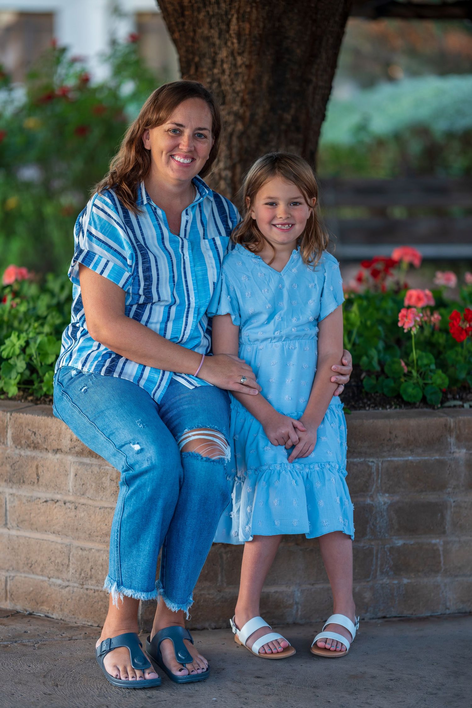 Casual family portraits taken outdoors with everyone dressed in coordinating blue outfits.