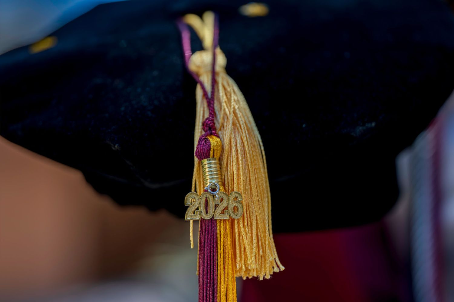 Close-up of a 2026 graduation cap tassel in gold and maroon colors marking a milestone achievement.