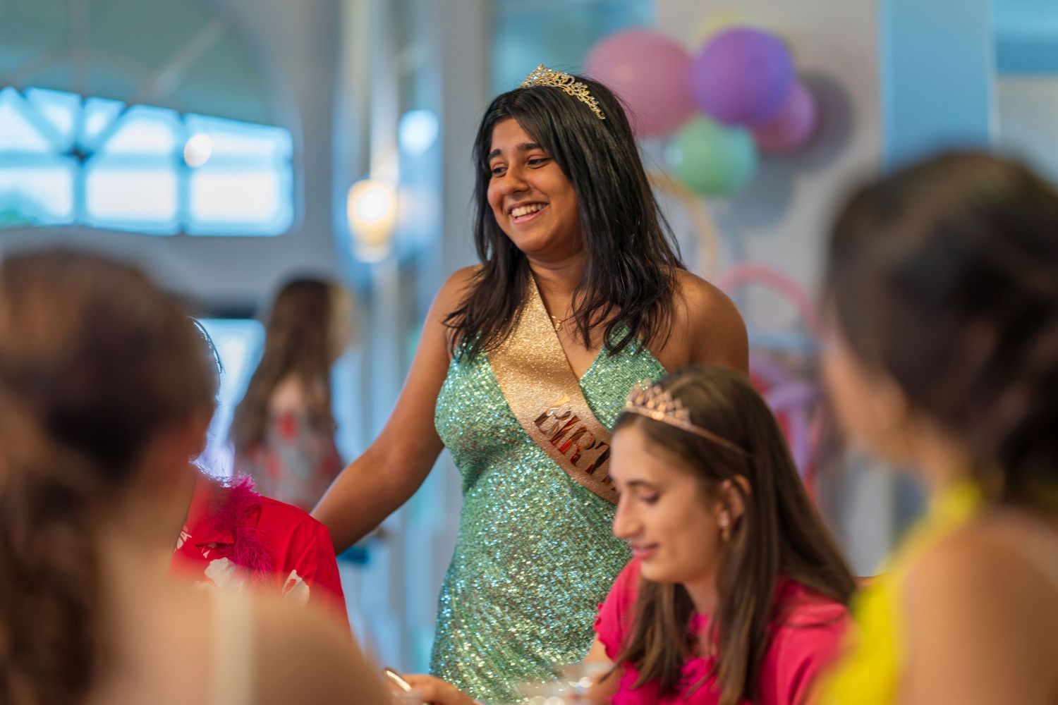 Festive party scene with colorful balloons and decorations.