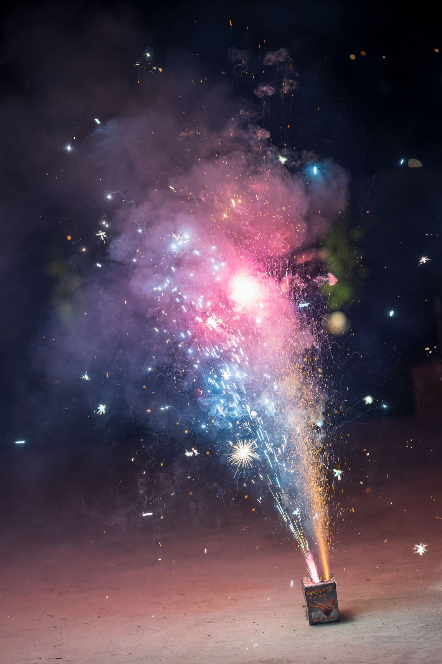 Colorful firework explosion against dark night sky creating a spectacular display.