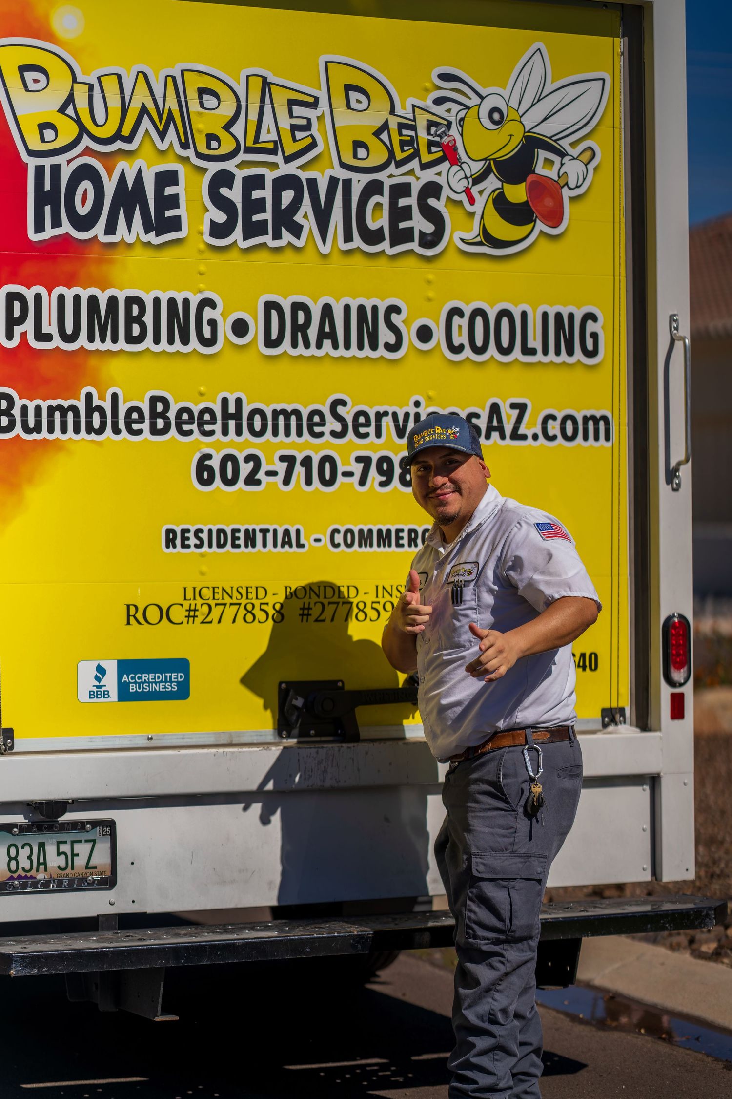 Yellow Bumble Bee Home Services van with company branding and contact information displayed on the side.