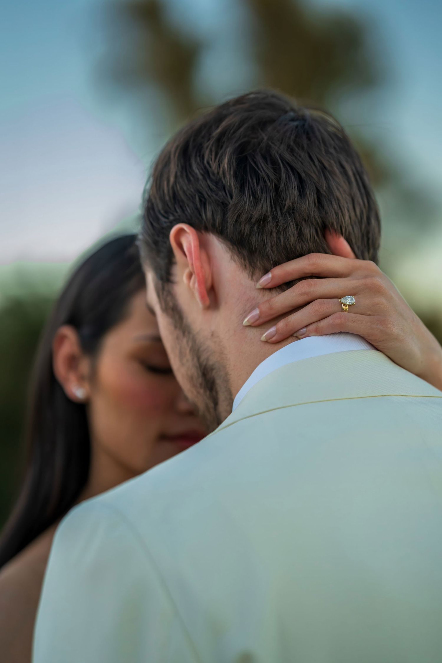 Intimate wedding portrait showing gentle embrace from behind.