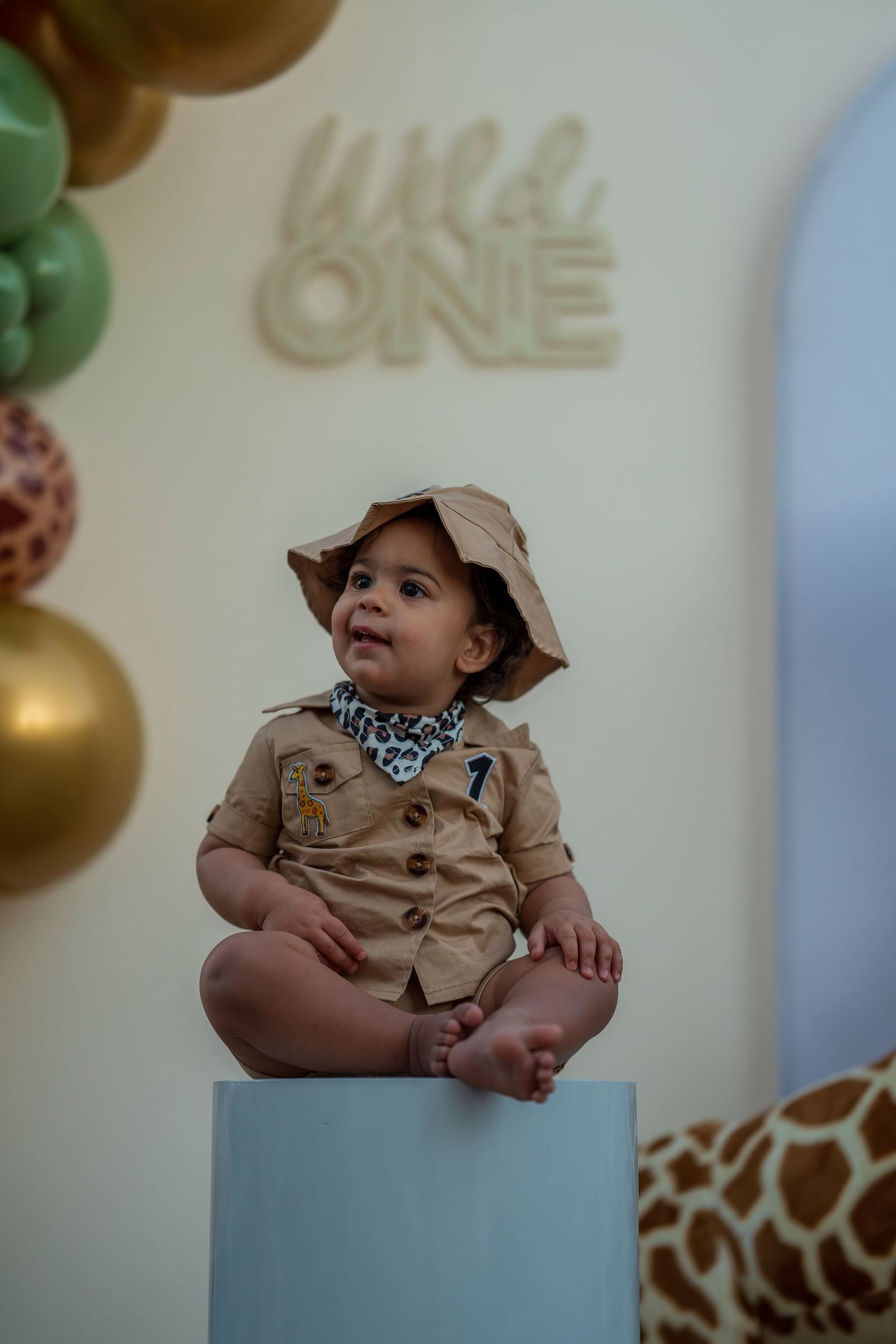 Safari-themed first birthday party setup with decorative elements and seating.