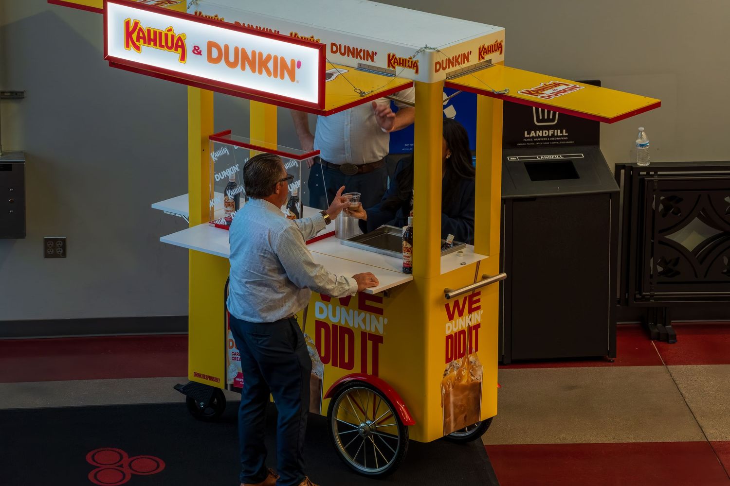 Yellow and red food vendor cart setup in an indoor space.