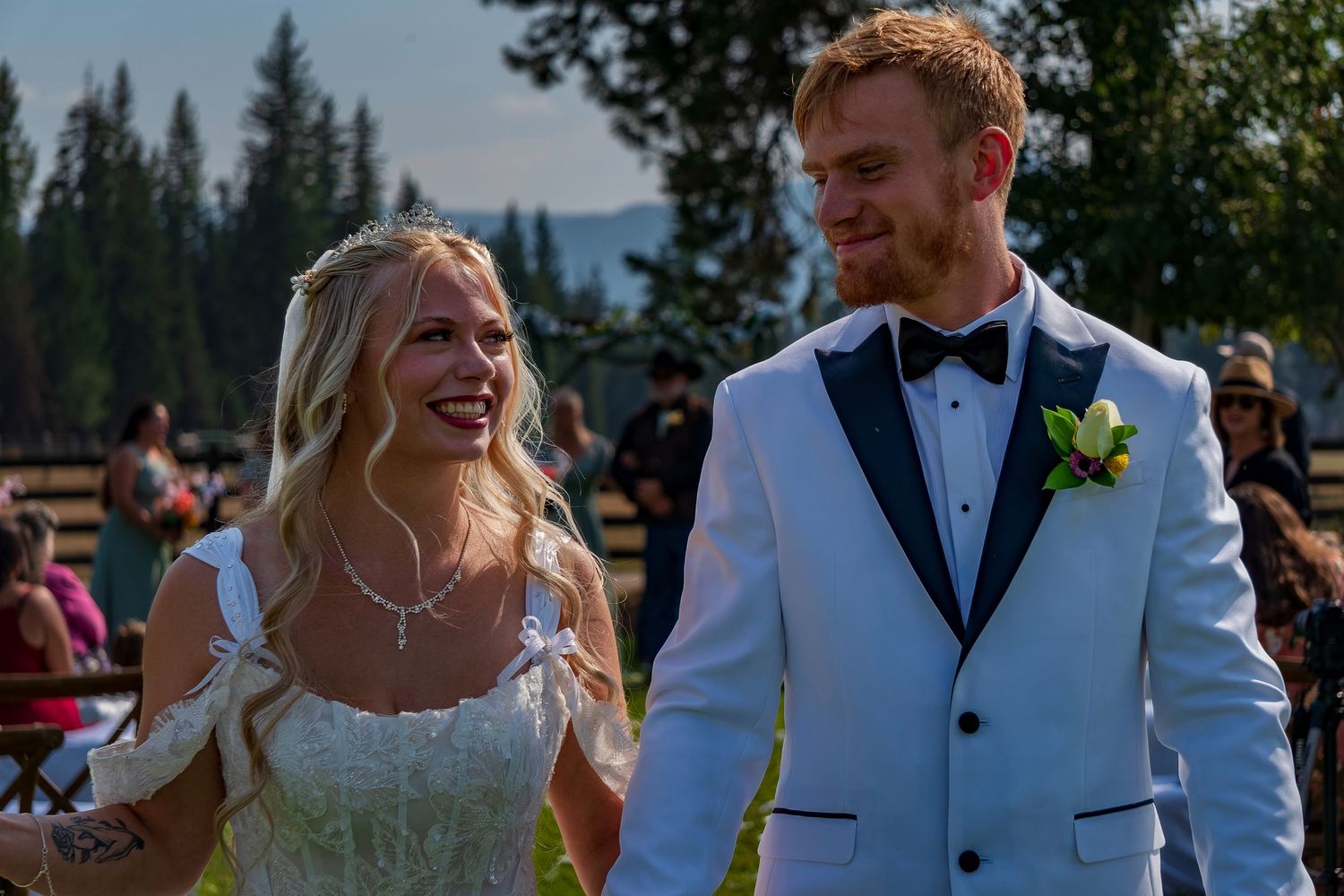Happy couple celebrating after ceremony at outdoor mountain wedding venue.