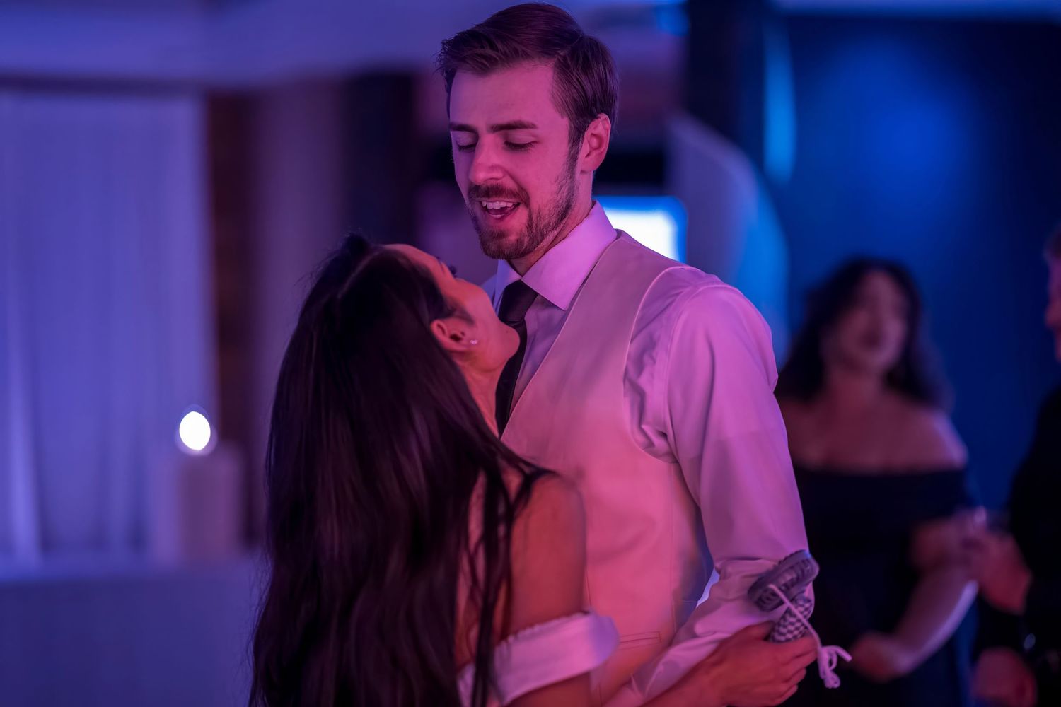 A couple shares a romantic dance moment at their wedding reception.