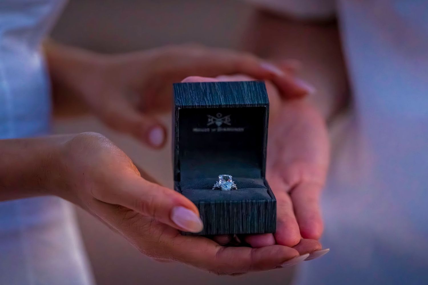 Black ring box being presented during a sunset proposal moment.