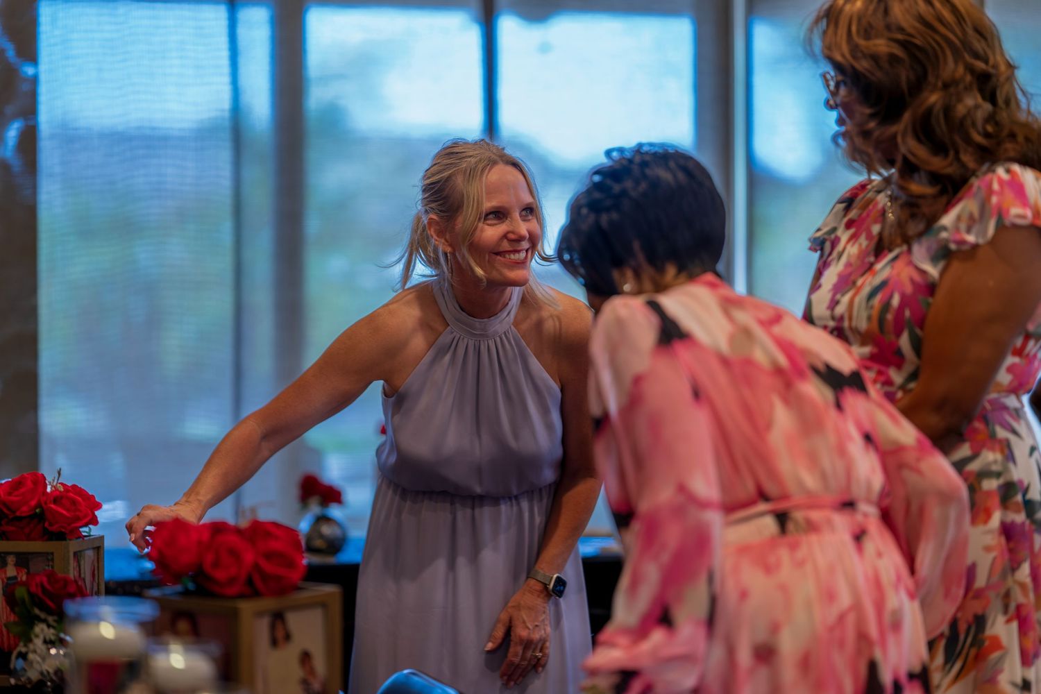 Women in colorful dresses gather at a celebration.