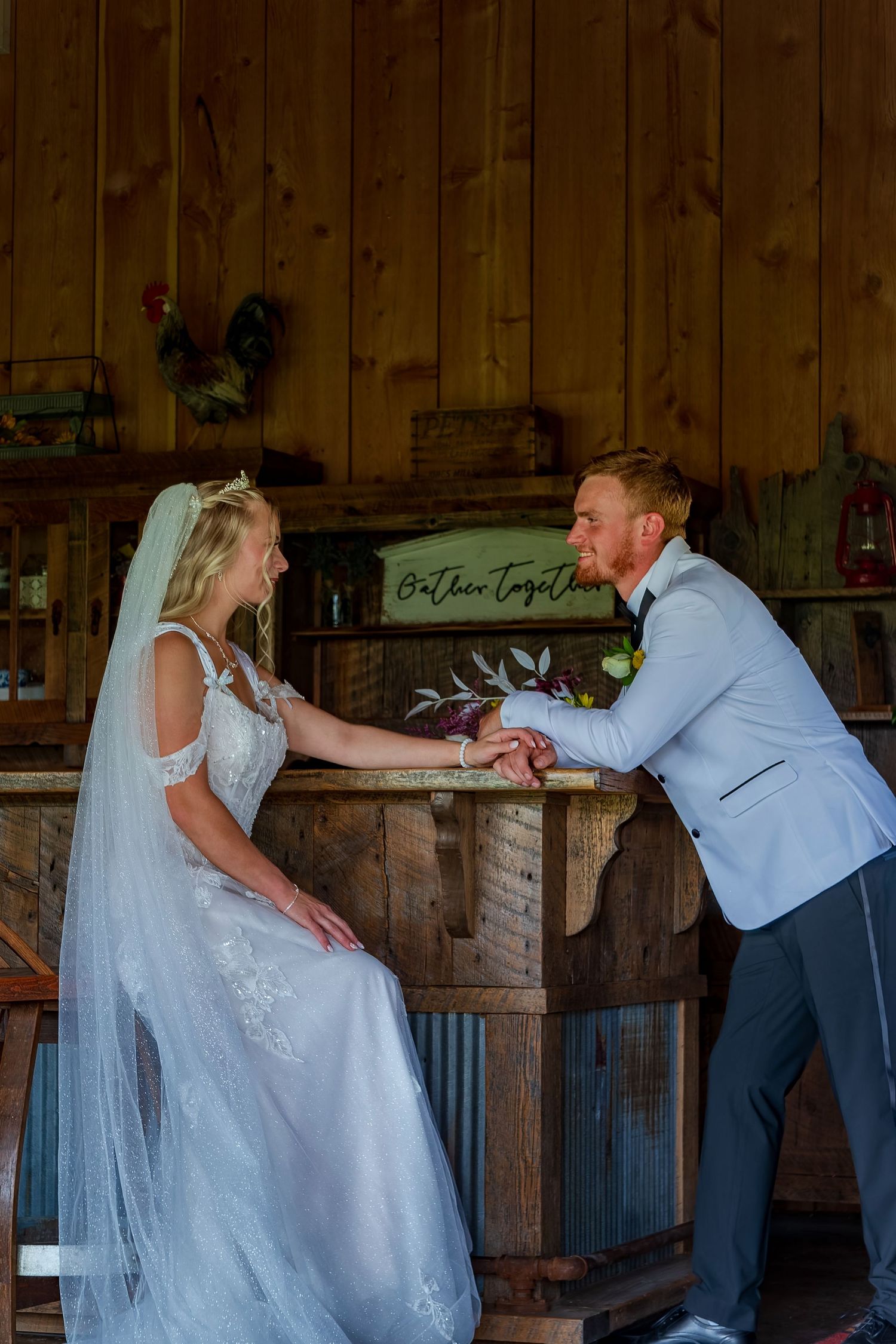 Couple dancing in rustic barn with playful dip pose.