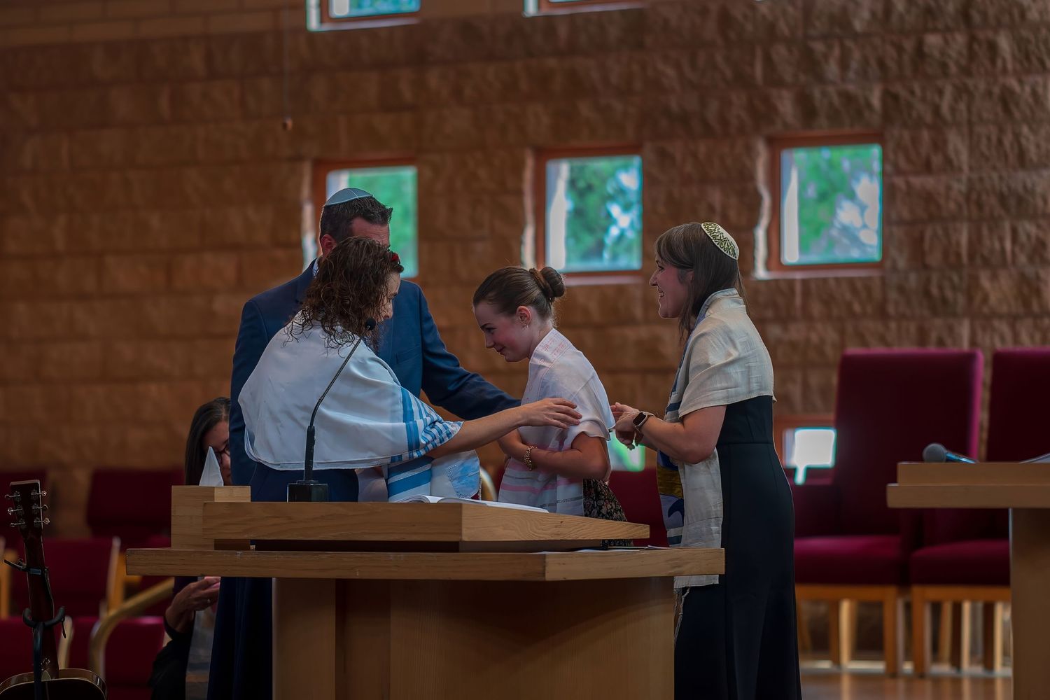 People gathered around a podium in a church during a religious ceremony or service.