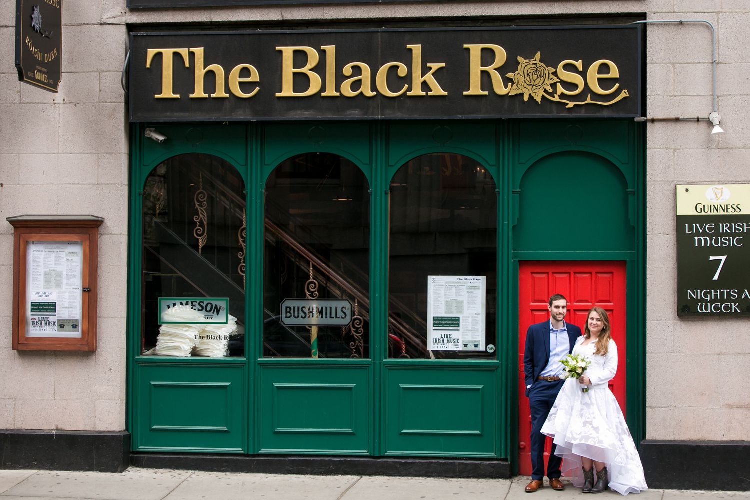 Bride and groom posing outside The Black Rose pub on their wedding day in Boston, Xenia Helix Photography, Boston, MA