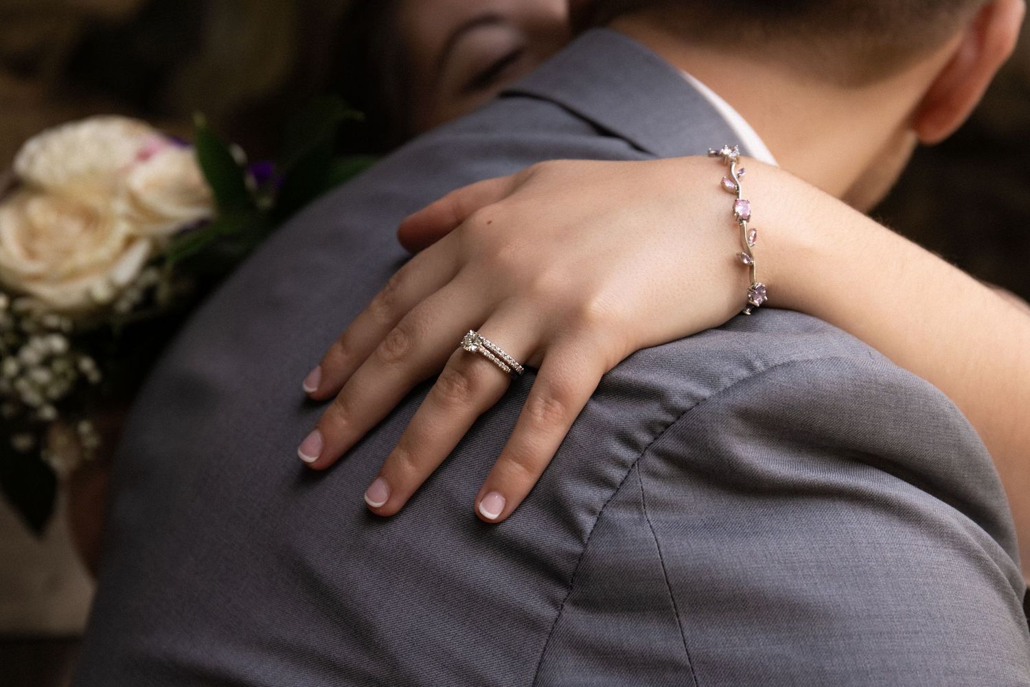 Bride rests her hand on groom's shoulder showcasing her diamond engagement ring and delicate bracelet, Estate at Moraine Farm, Beverly, MA
