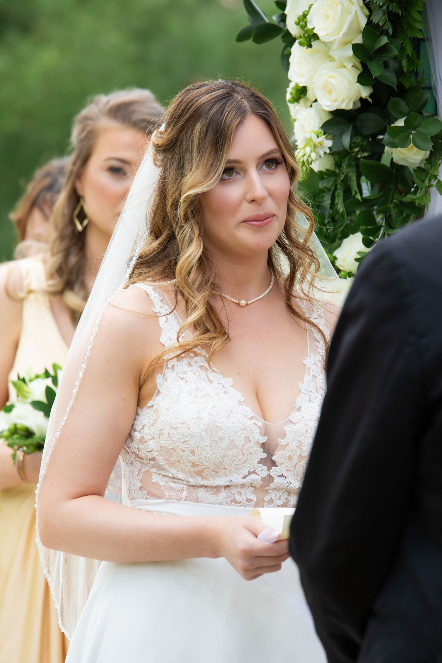 Blonde bride in lace wedding gown and veil gazing at groom during outdoor wedding ceremony, Xenia Helix Photography, Boston, MA