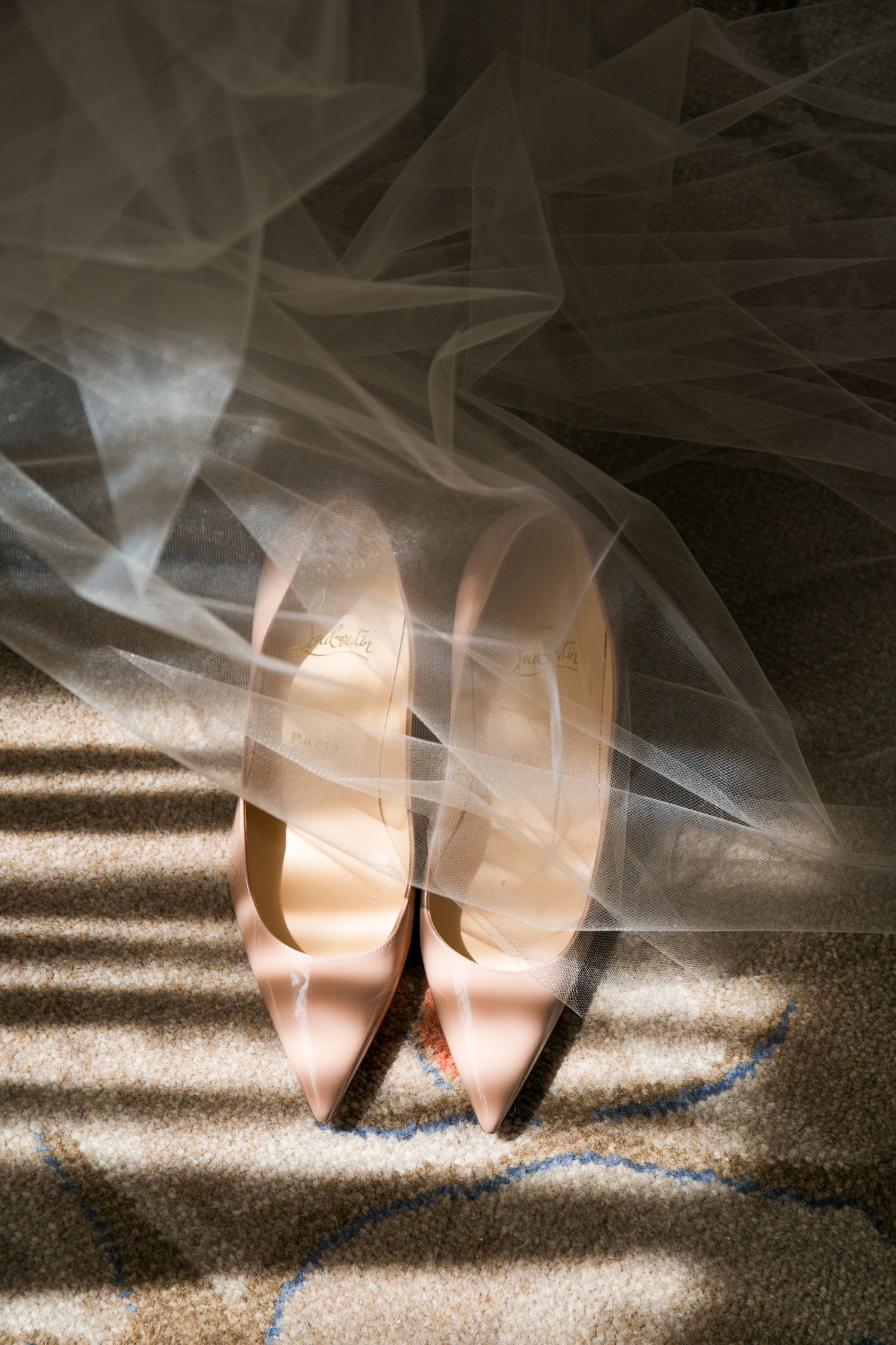 Nude leather bridal heels peeking beneath a flowing tulle veil in soft natural light, Mandarin Oriental Boston, Boston, MA