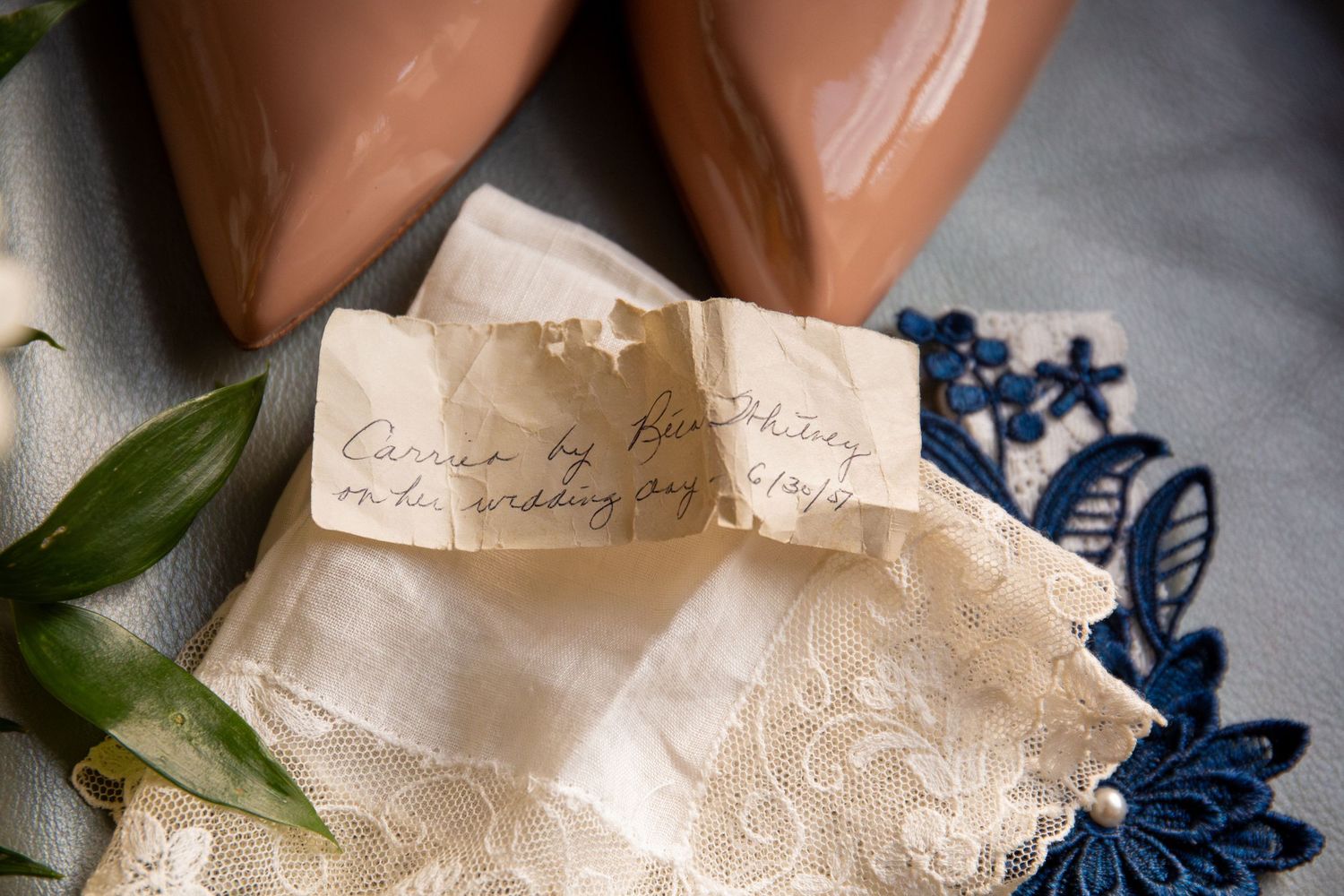 Handwritten note on a lace handkerchief beside blush heels, a sentimental wedding day keepsake, Battery Wharf Hotel, Boston, MA