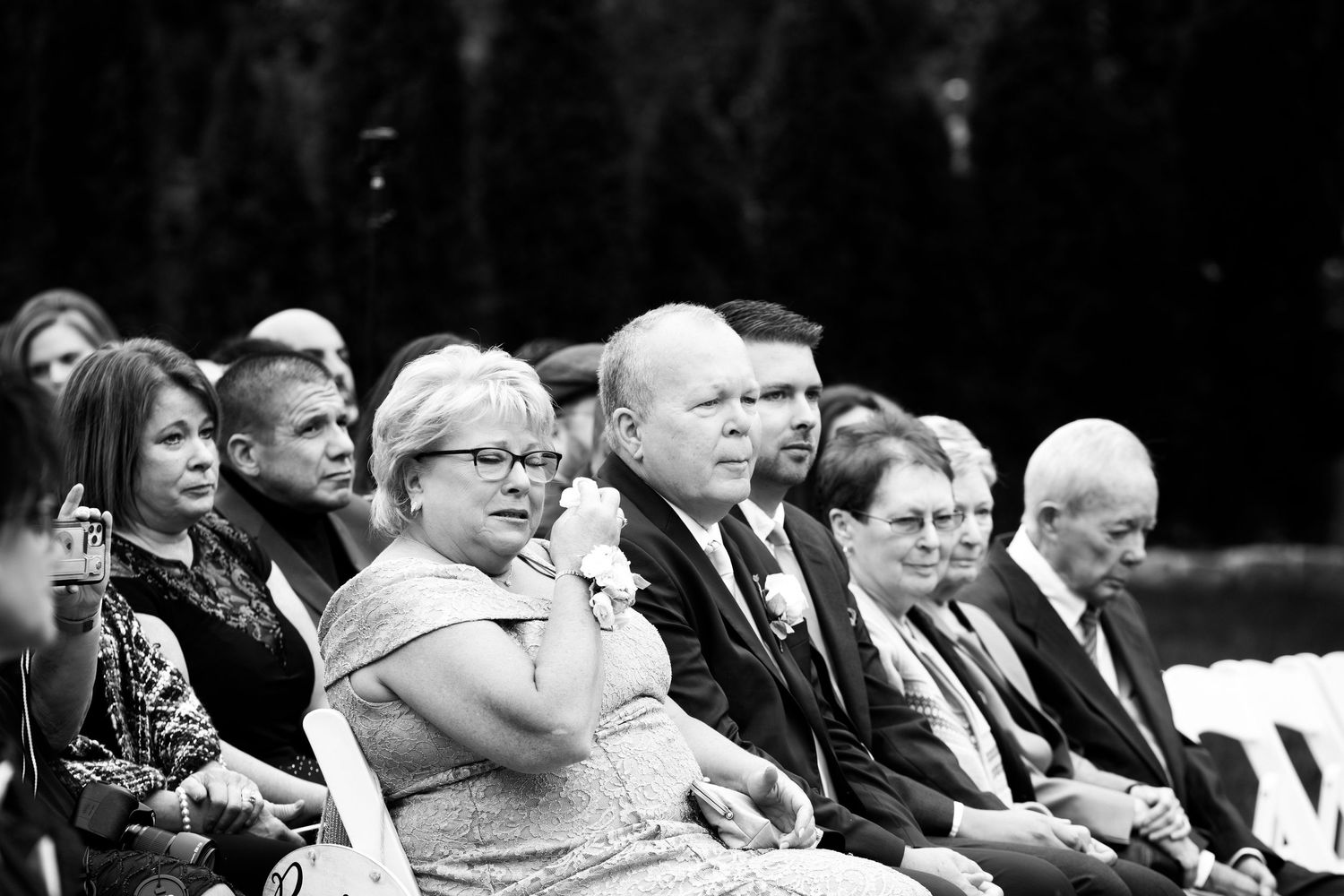 Wedding guests seated at outdoor ceremony watching proceedings in black and white photo, Coachmen's Lodge, Bellingham, MA