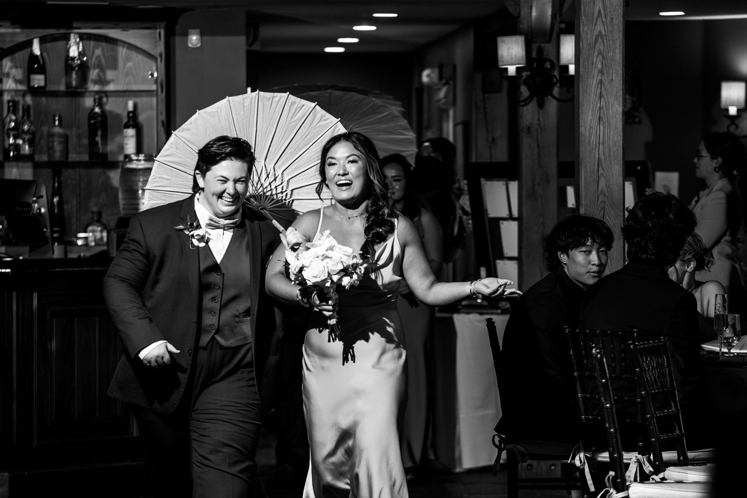 Wedding party walking into the reception with a parasol and bouquet, black-and-white photo, Harrington Farm, Princeton, MA