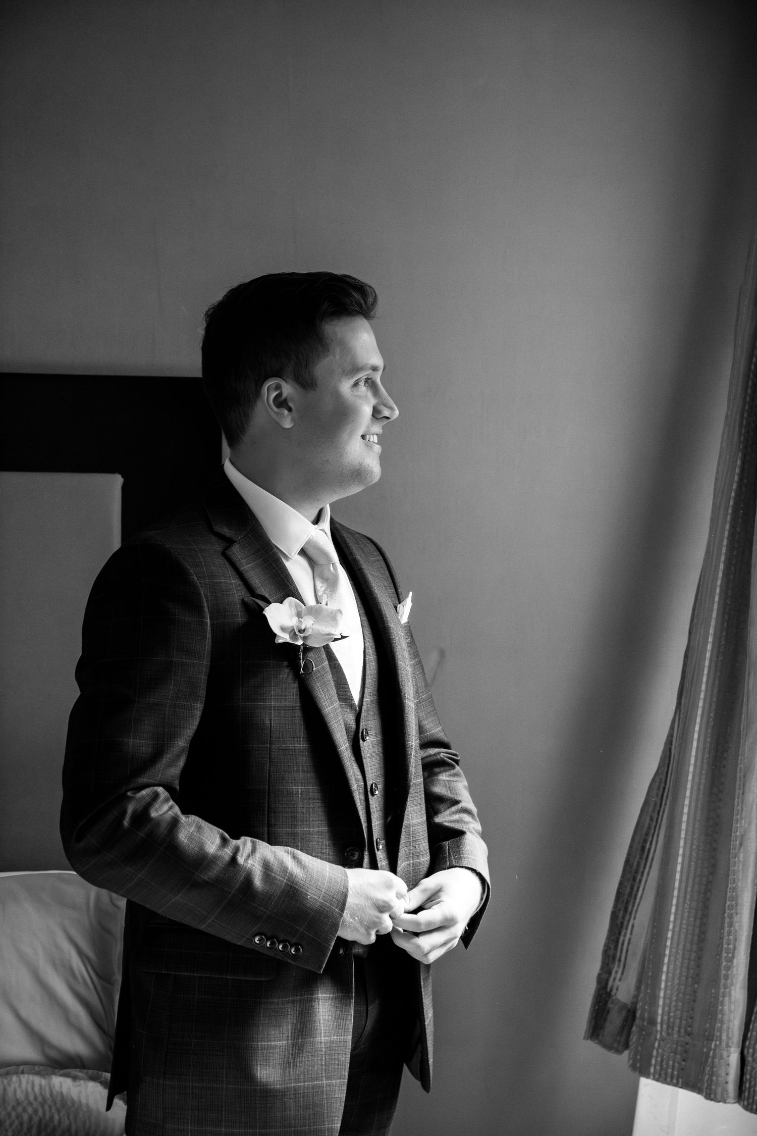 Dapper groom in a three-piece checked suit with boutonniere preparing for his wedding, Harrington Farm, Princeton, MA