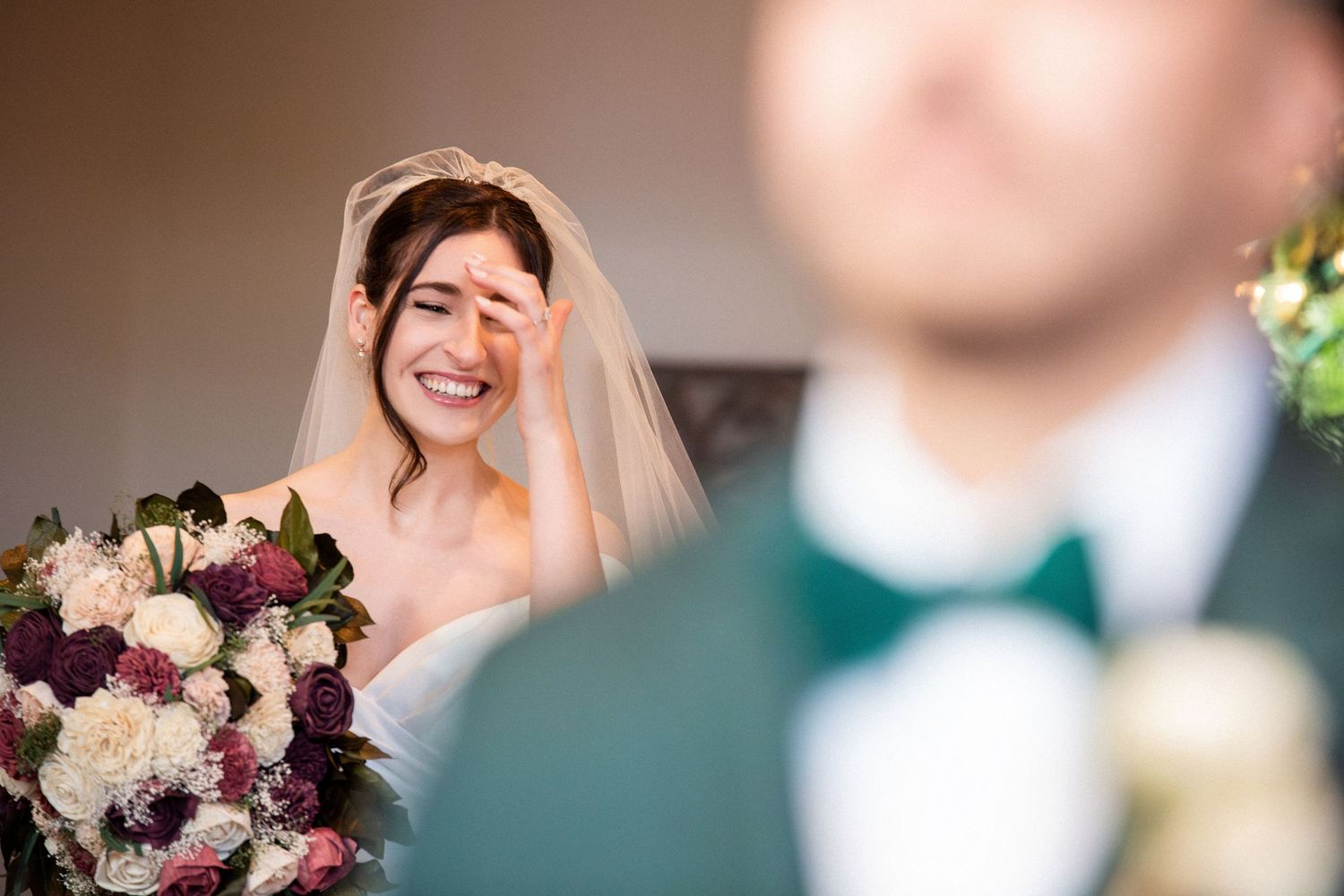 Tearful bride smiles holding a bouquet as she sees groom in green suit for the first time, Grove at Briar Barn Inn, Rowley, MA