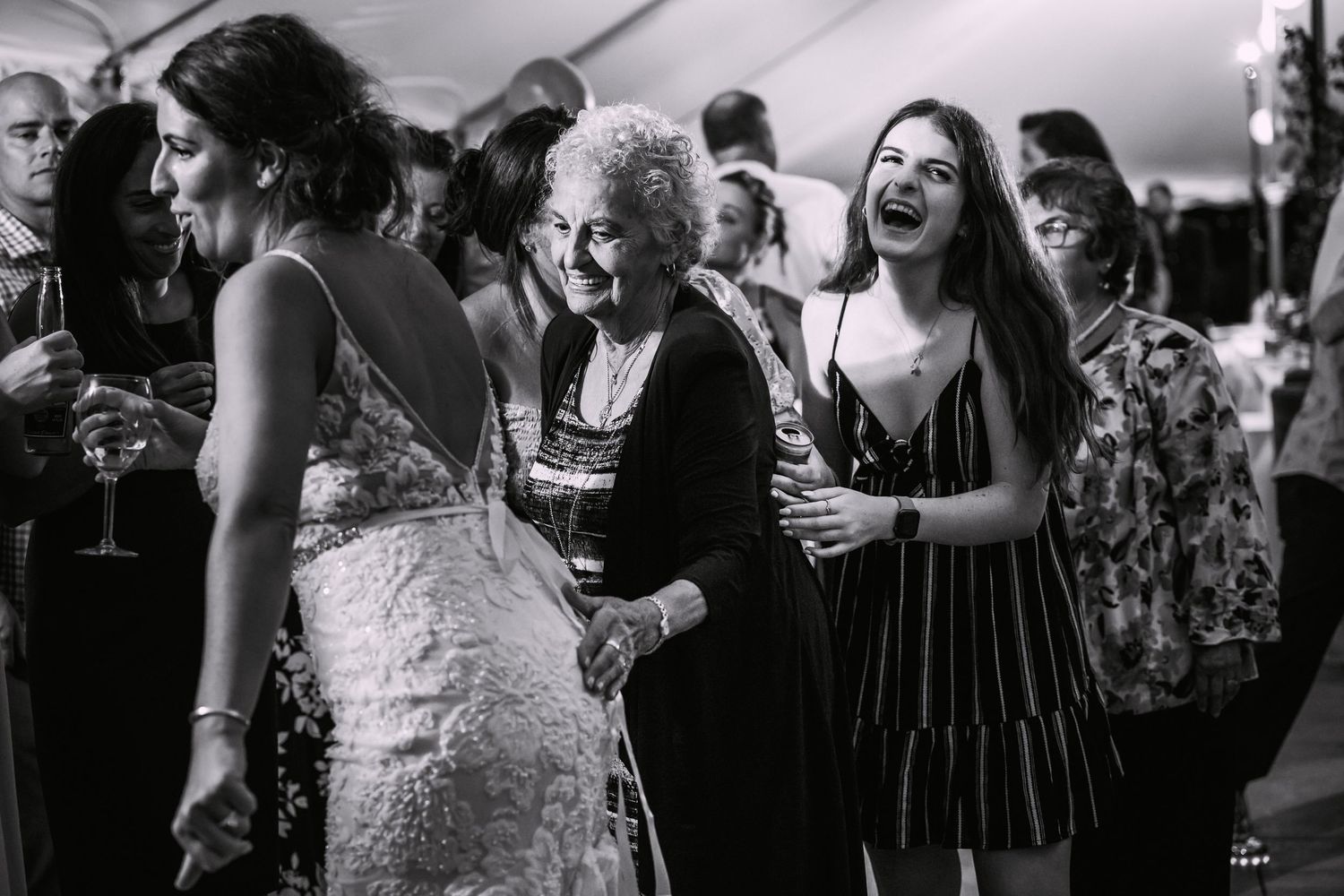Elderly woman laughing joyfully with guests at a wedding reception in black and white photo, East Bay Grille, Plymouth, MA