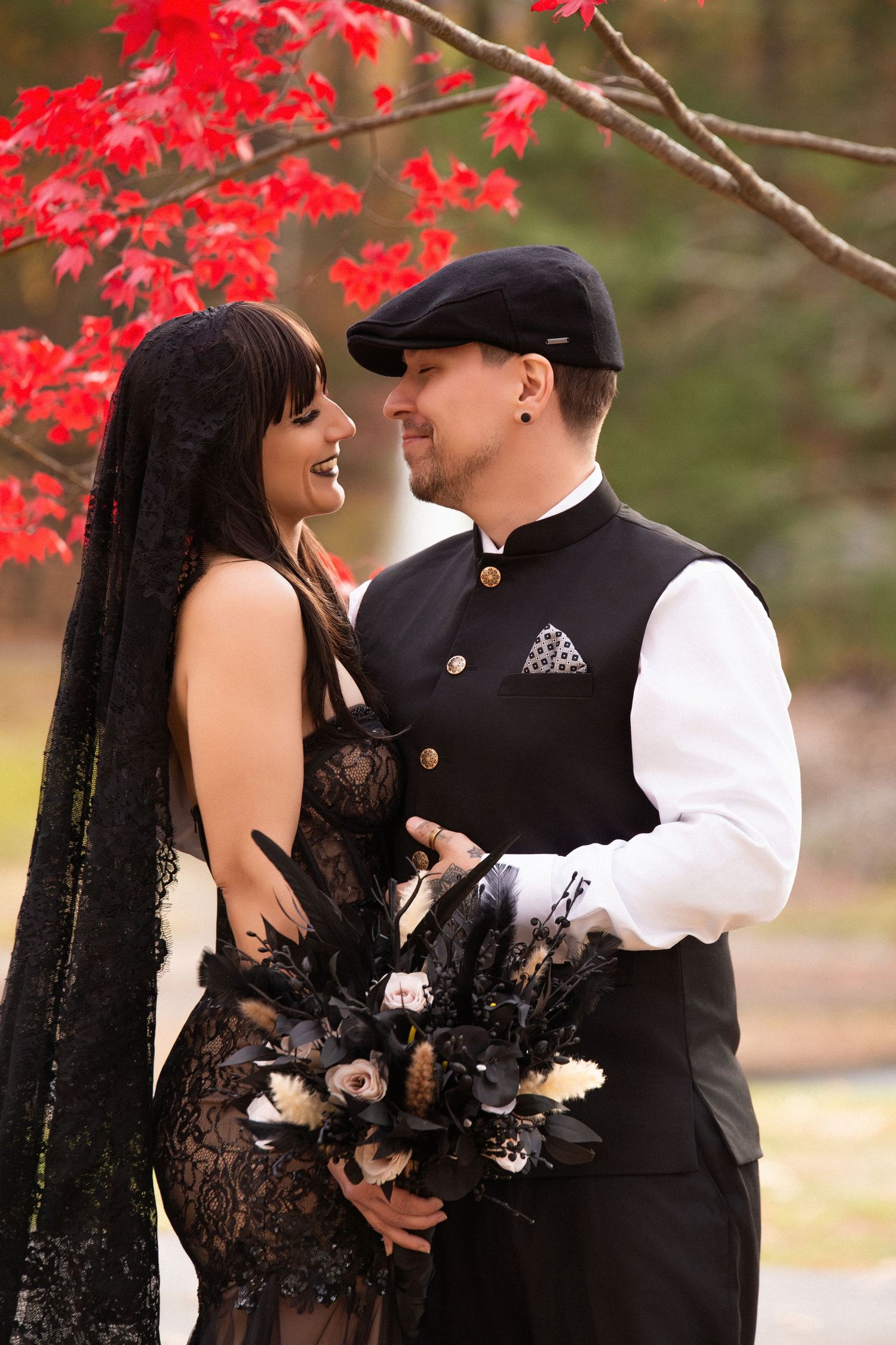Gothic-style bride and groom in black attire under a red maple tree with a dark floral bouquet, The Chapel at West Parish, Andover, MA