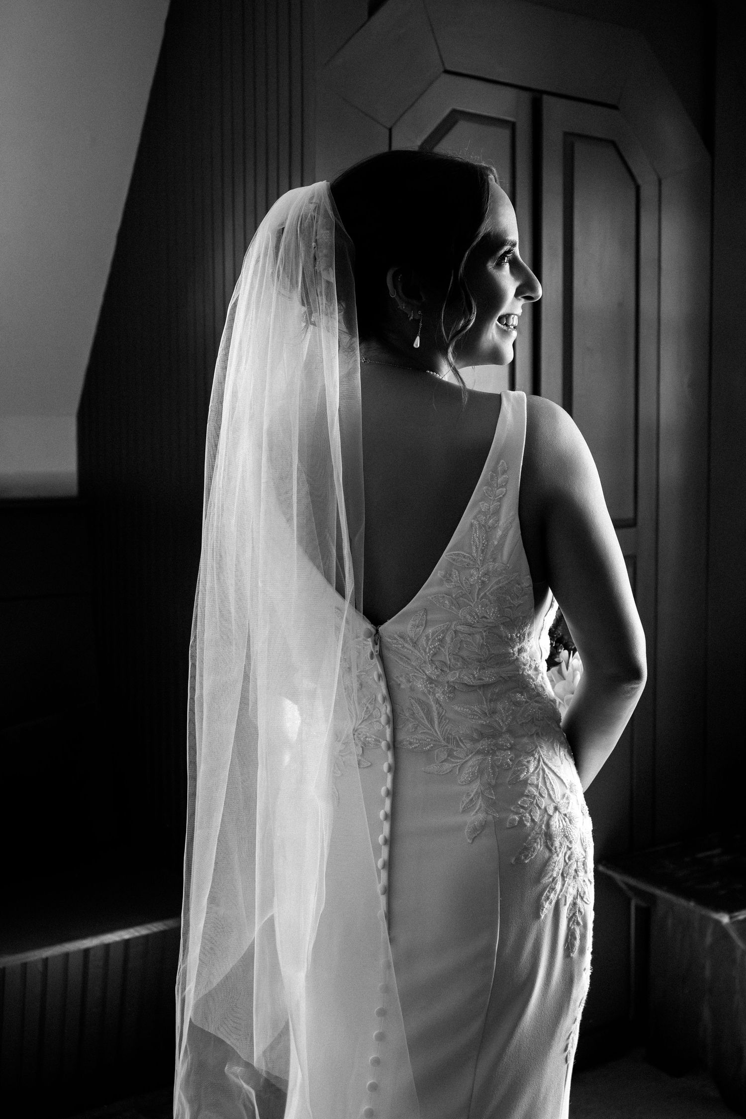 Elegant bride in lace gown and veil poses in dramatic black and white portrait, The Red Lion Inn, Cohasset, MA
