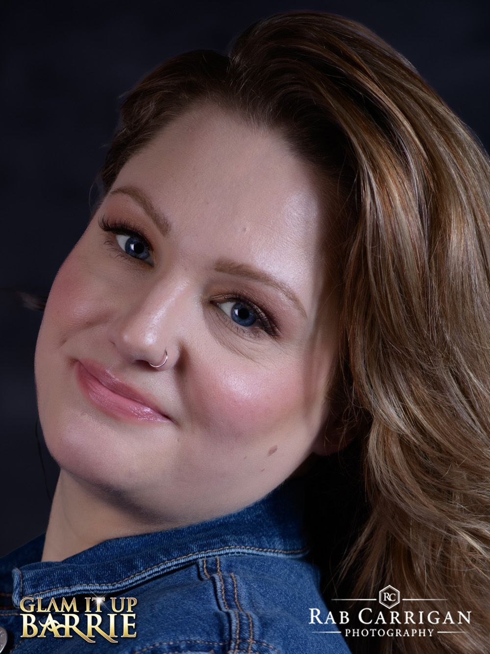 A close up Professional portrait of a woman in a denim jacket highlighting her natural beauty and confident smile.