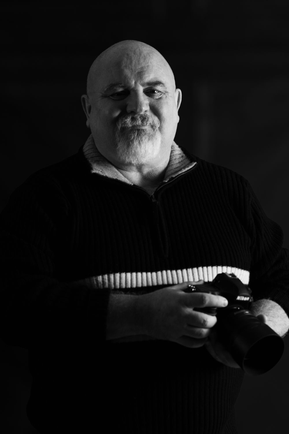 Dramatic black and white portrait series showing a person in dark clothing holding a camera.