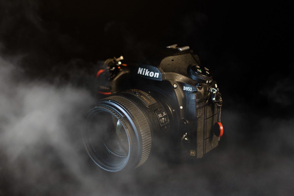 Nikon D850 camera with cinematic atmospheric smoke effects in a professional Barrie studio setting.