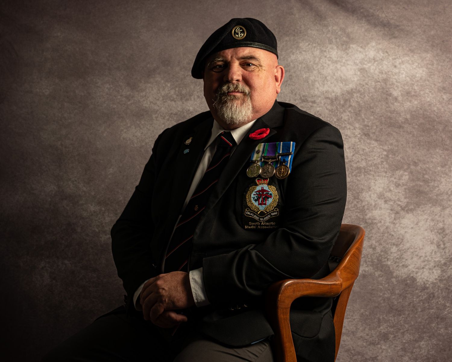 Portrait of photographer Rab Carrigan in veteran uniform; showcasing technical lighting mastery at his Barrie studio.