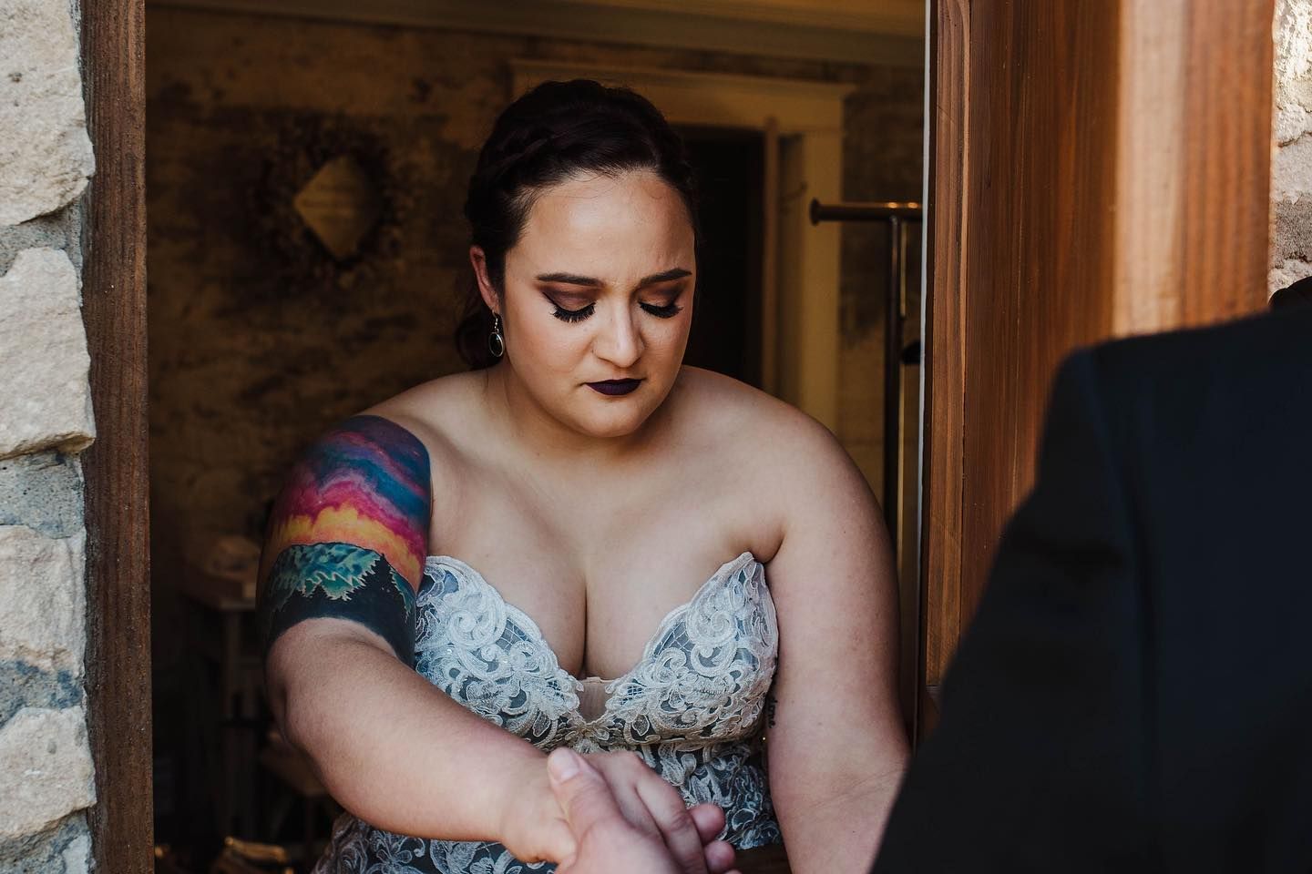Romantic indoor portraits with rustic brick wall backdrop.
