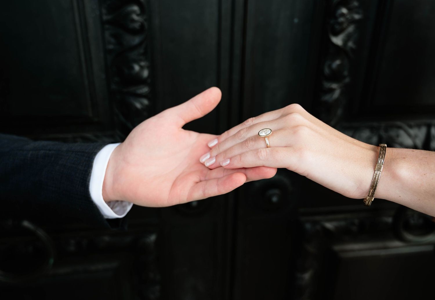 Close-up sequence of hands exchanging rings during a wedding ceremony.