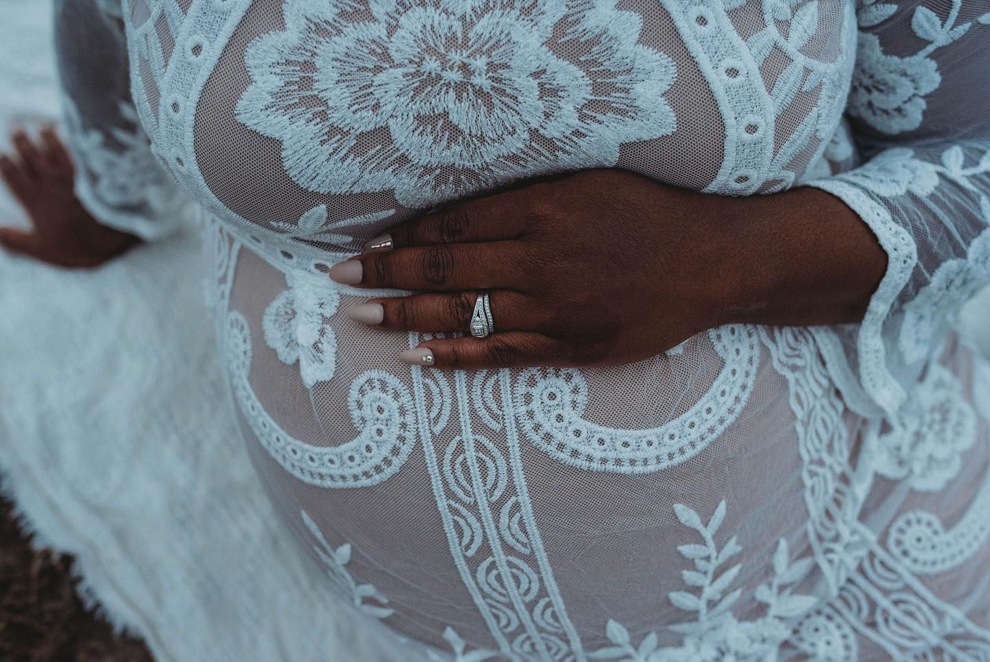 Delicate lace and floral details create an elegant pattern on a white background.