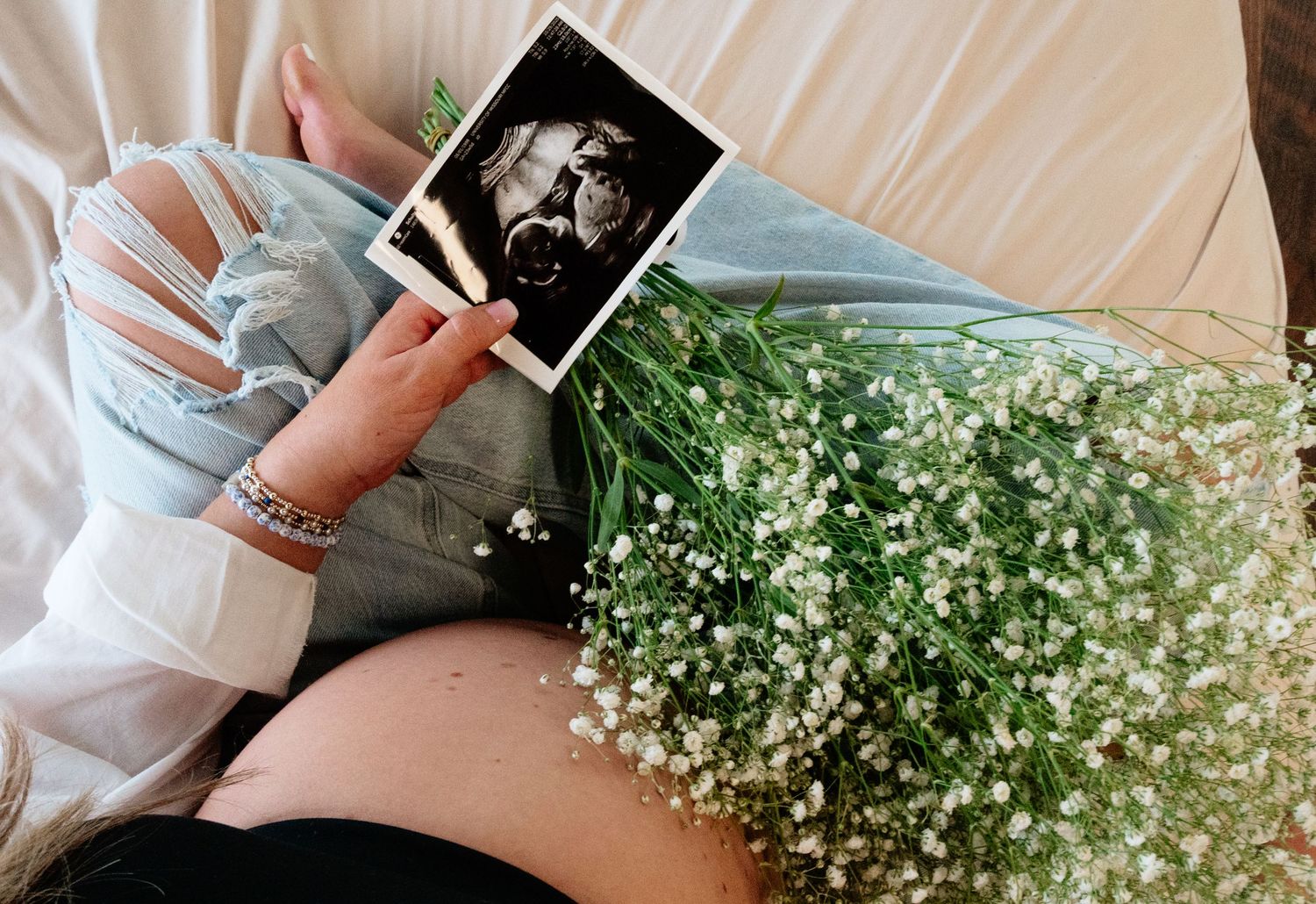 Baby's breath flowers and vintage photographs create a nostalgic display.