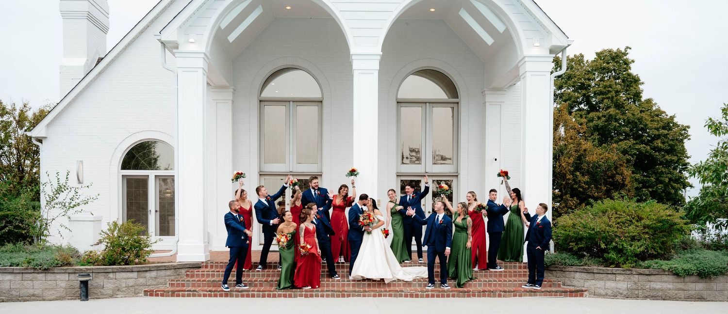 White church exterior with classic architectural details and gathered guests.