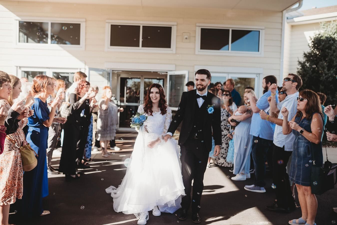 Wedding guests cheer and celebrate during a joyous reception party.