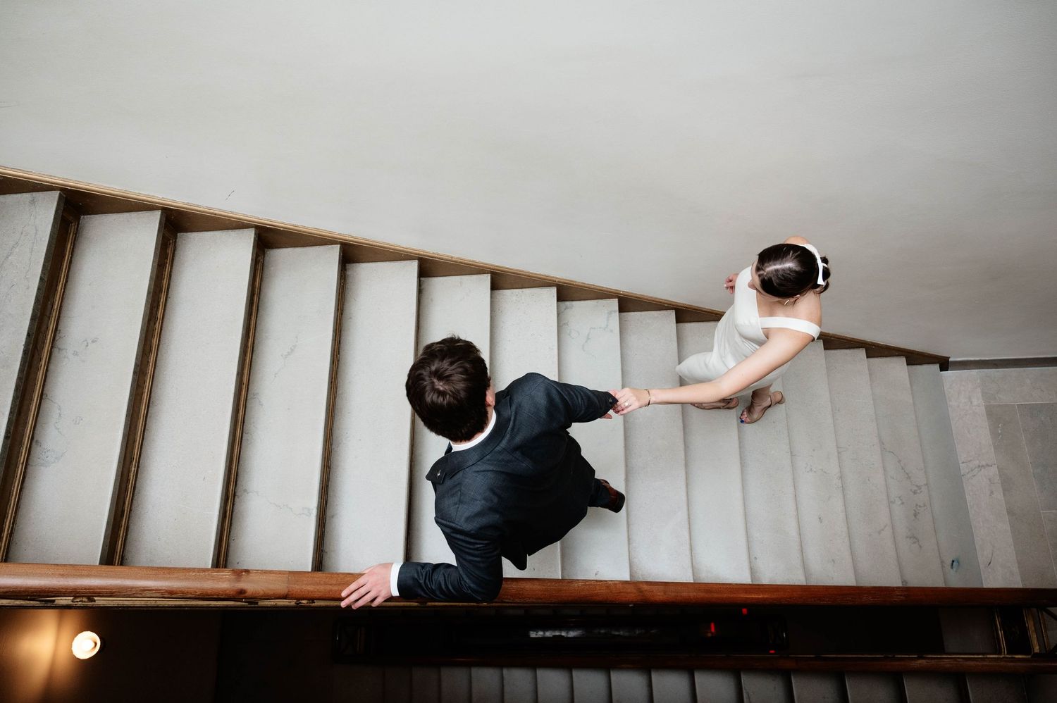 Creative sequence of people posing on an indoor staircase in black and white.