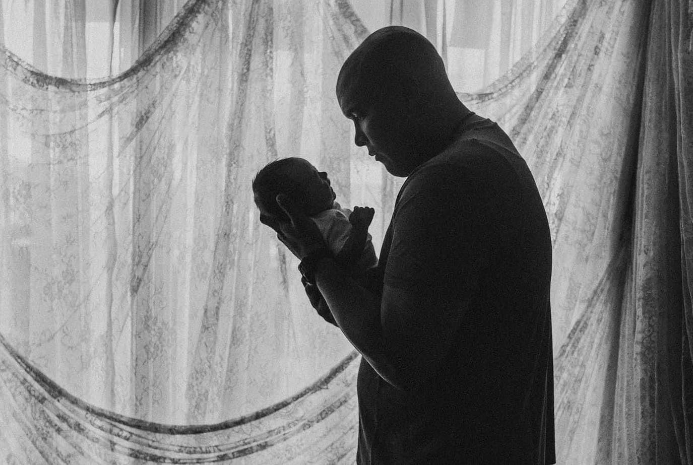 Black and white silhouettes of people embracing in an artistic sequence.