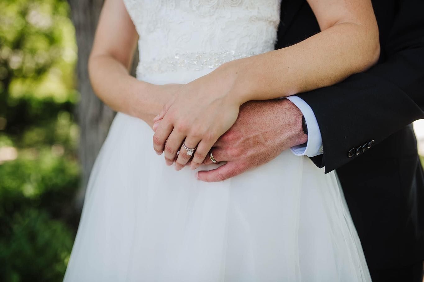Close-up details of white wedding dress and formal attire.