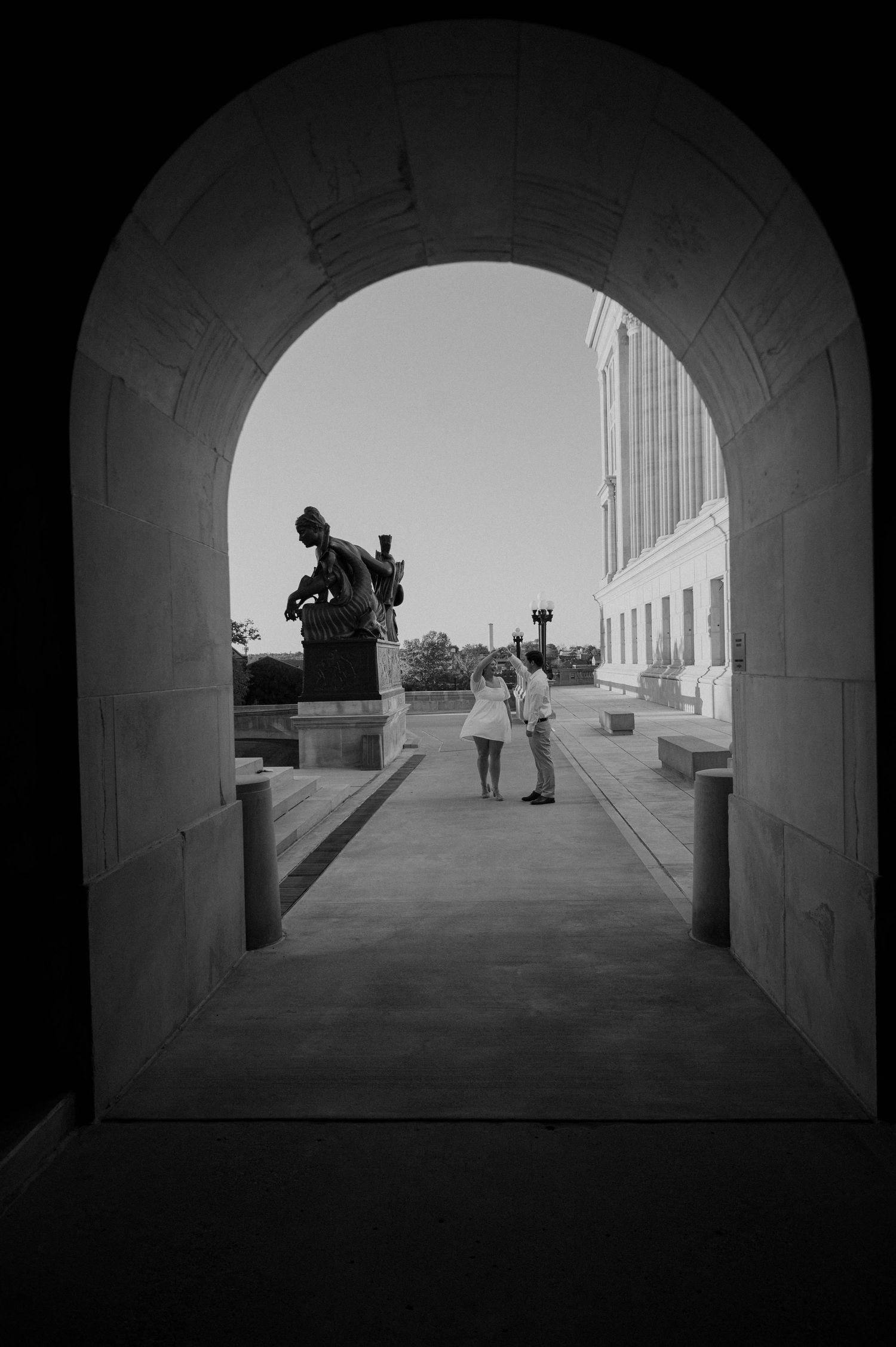Black and white photos showing silhouettes through an arched passageway.